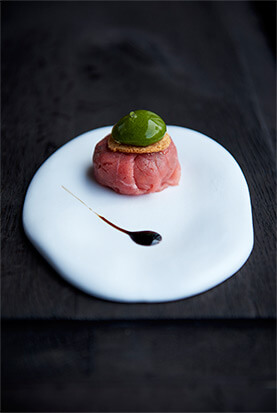 Slice of tartare of Mediterranean beef with a bubble of basil
